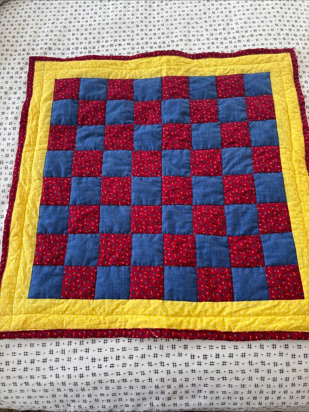 Quilted piece, 24x24”, red and navy w/ yellow border and back, handmade, cotton